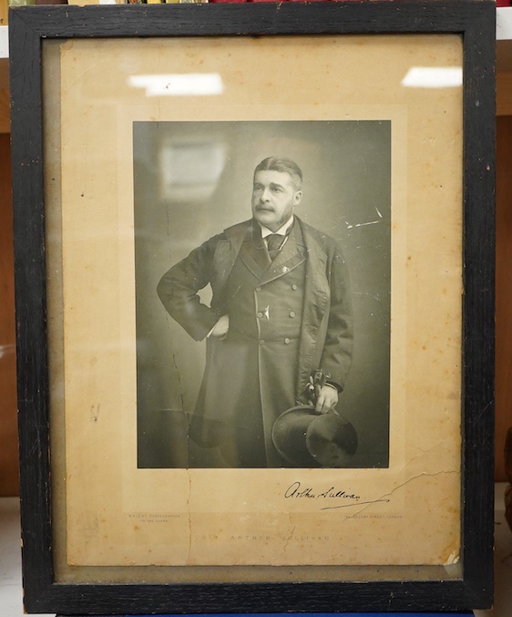 A Gilbert and Sullivan Opera model theatre, with printed card figures from the Mikado, together with a portrait photograph of Sir Arthur Sullivan loosely contained within a stained wood frame, the photograph is unmounted